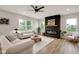 Bright living room with a modern fireplace, neutral decor, and large windows offering scenic views at 1147 Kelsneland Dr, Avon, IN 46123