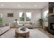 Spacious living room featuring neutral sofas, decorative accents, and large windows with an outside view at 1147 Kelsneland Dr, Avon, IN 46123