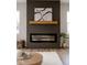Modern fireplace with wood mantle and shiplap accent wall at 1147 Kelsneland Dr, Avon, IN 46123