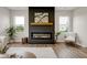 Inviting living room with a modern fireplace, stylish wood mantel and windows offering natural light at 1147 Kelsneland Dr, Avon, IN 46123