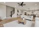 Bright, open-concept living room featuring modern furnishings and wood-look flooring, seamlessly connected to dining area at 1147 Kelsneland Dr, Avon, IN 46123