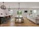 Open concept living space featuring a kitchen island, dining table, and comfortable seating area at 1147 Kelsneland Dr, Avon, IN 46123
