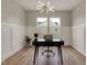 Bright home office with modern light fixture, paneled walls, and large windows at 1147 Kelsneland Dr, Avon, IN 46123
