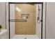 The walk-in shower features white subway tile, light wood paneling and modern, black hardware at 1147 Kelsneland Dr, Avon, IN 46123