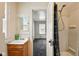 Modest bathroom features a wood vanity, mirror and a shower with curtain at 1235 N Grant Ave, Indianapolis, IN 46201