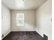 Vacant room featuring neutral carpet, a window, and natural light at 1235 N Grant Ave, Indianapolis, IN 46201