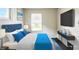 Bright bedroom with modern furniture, and natural light from a window at 1235 N Grant Ave, Indianapolis, IN 46201