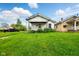 Quaint one-story home featuring a well-maintained lawn and inviting front porch at 1235 N Grant Ave, Indianapolis, IN 46201