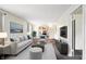 Bright living room featuring neutral walls, carpet, and views to the kitchen at 1235 N Grant Ave, Indianapolis, IN 46201