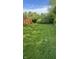 Lush backyard featuring green grass, mature trees, and a privacy fence for outdoor enjoyment at 12551 Hawks Landing Dr, Fishers, IN 46037