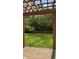 A large grass backyard surrounded by a wood fence, and a pergola over a stone patio at 12551 Hawks Landing Dr, Fishers, IN 46037
