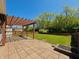 Spacious backyard features a stone patio with pergola, a fire pit, and a well-manicured lawn at 12551 Hawks Landing Dr, Fishers, IN 46037