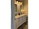 Bathroom vanity featuring double sinks, granite counters, and ample storage with dark hardware at 12551 Hawks Landing Dr, Fishers, IN 46037