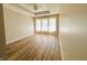 Bright bedroom featuring wood floors, tray ceiling and window with natural light at 12551 Hawks Landing Dr, Fishers, IN 46037
