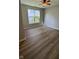 Bedroom featuring modern ceiling fan, wood laminate floors, and natural light from the window at 12551 Hawks Landing Dr, Fishers, IN 46037