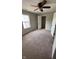 A well-lit bedroom features a ceiling fan and a closet, offering comfort and convenience at 12551 Hawks Landing Dr, Fishers, IN 46037