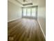 Spacious bedroom with wood floors, ceiling fan and multiple windows at 12551 Hawks Landing Dr, Fishers, IN 46037