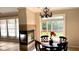 Bright breakfast nook with a fireplace, chandelier, and views of the backyard at 12551 Hawks Landing Dr, Fishers, IN 46037