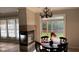 Open dining area with a fireplace, a hanging chandelier, and backyard views at 12551 Hawks Landing Dr, Fishers, IN 46037