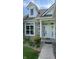 Inviting entrance with a classic white door, decorative sidelights and a well-kept garden at 12551 Hawks Landing Dr, Fishers, IN 46037