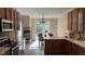 Open kitchen/dining space with a cozy fireplace, and a dining table with a view to the patio at 12551 Hawks Landing Dr, Fishers, IN 46037