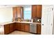 Kitchen features wood cabinets, light countertops, stainless steel appliances, and tile flooring at 12551 Hawks Landing Dr, Fishers, IN 46037