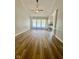 Spacious living room featuring hardwood floors, neutral paint, a ceiling fan, and a cozy fireplace at 12551 Hawks Landing Dr, Fishers, IN 46037