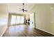 Bright living room with a fireplace, ceiling fan, hard wood floors, and big window for natural lighting at 12551 Hawks Landing Dr, Fishers, IN 46037