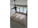 Bright living room with hardwood floors, ceiling fan, and large windows for natural light at 12551 Hawks Landing Dr, Fishers, IN 46037