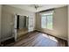 Well-lit office space with hardwood floors, a ceiling fan, french doors, and a large window with natural light at 12551 Hawks Landing Dr, Fishers, IN 46037