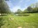 Scenic view of a pond with a fountain and lush greenery at 12551 Hawks Landing Dr, Fishers, IN 46037