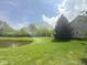 Scenic view of a large pond with lush greenery at 12551 Hawks Landing Dr, Fishers, IN 46037