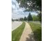 Peaceful sidewalk bordered by lush greenery and a classic white fence at 12551 Hawks Landing Dr, Fishers, IN 46037