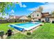 Spacious backyard featuring an inviting pool, outdoor dining and lounge areas, perfect for entertaining and relaxation at 12984 Shandon Ln, Fishers, IN 46038