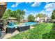 Expansive backyard showcasing a sparkling pool, multiple seating areas, and well-maintained greenery at 12984 Shandon Ln, Fishers, IN 46038