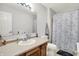 Bright bathroom featuring a vanity, toilet, and shower with patterned curtain at 12984 Shandon Ln, Fishers, IN 46038