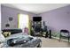 Bedroom with purple walls, carpet, and a desk setup at 12984 Shandon Ln, Fishers, IN 46038