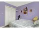 Small bedroom with purple walls, a closet, and personal touches at 12984 Shandon Ln, Fishers, IN 46038