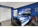 Bedroom featuring blue walls, carpet and Indianapolis Colts decor at 12984 Shandon Ln, Fishers, IN 46038