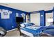 Bedroom featuring Indianapolis Colts decor, carpet, and blue walls at 12984 Shandon Ln, Fishers, IN 46038