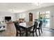 An open dining area features a wood table with seating, a sliding door and a view of the pool at 12984 Shandon Ln, Fishers, IN 46038