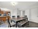 Open floor plan features a dining area with a dark wood table and a seating bench at 12984 Shandon Ln, Fishers, IN 46038