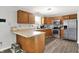 Well-lit kitchen featuring stainless steel appliances and wood cabinets at 12984 Shandon Ln, Fishers, IN 46038