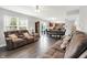 Open concept living room and dining area featuring a large sofa set, a wood table, and a view of the backyard at 12984 Shandon Ln, Fishers, IN 46038