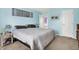 A tranquil main bedroom featuring light blue walls and plush carpeting at 12984 Shandon Ln, Fishers, IN 46038