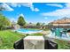 A serene backyard featuring a pristine pool, lush green lawn, and ample space for outdoor enjoyment at 12984 Shandon Ln, Fishers, IN 46038