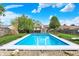 Stunning inground pool surrounded by a well-manicured lawn and clear blue sky at 12984 Shandon Ln, Fishers, IN 46038