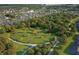 Aerial view of community dog park surrounded by trees and residences offering green space for pets and families at 13324 Roundtop Rd, Noblesville, IN 46060
