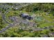 Picturesque aerial view of community amenities including a pool, tennis courts, a clubhouse, and lush landscaping at 13324 Roundtop Rd, Noblesville, IN 46060