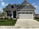 Charming single-story home featuring stone accents and a two-car garage at 13324 Roundtop Rd, Noblesville, IN 46060